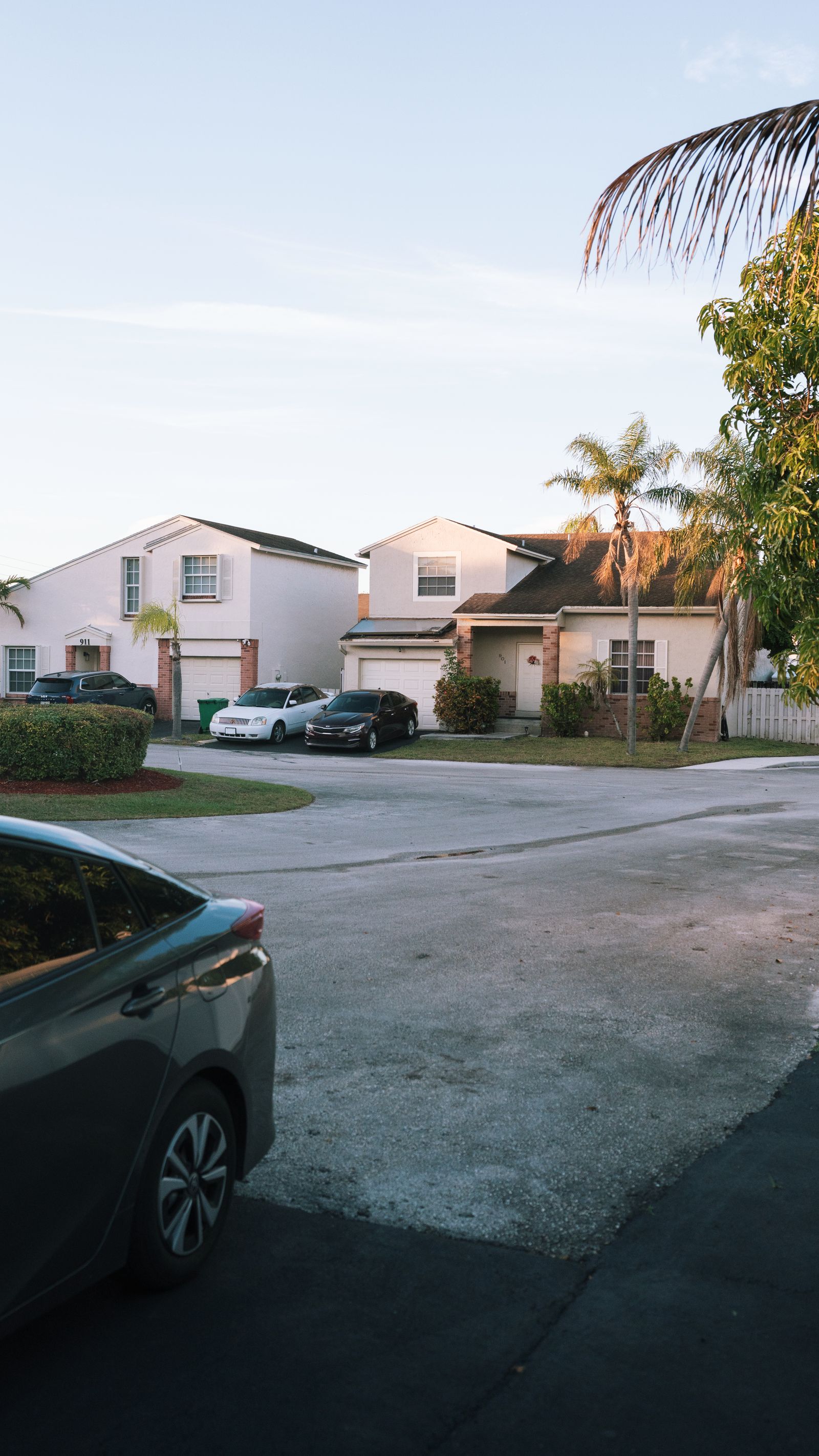 Two-story Florida single-family home with palm trees at dusk, representative of the collateral backing performing mortgage notes