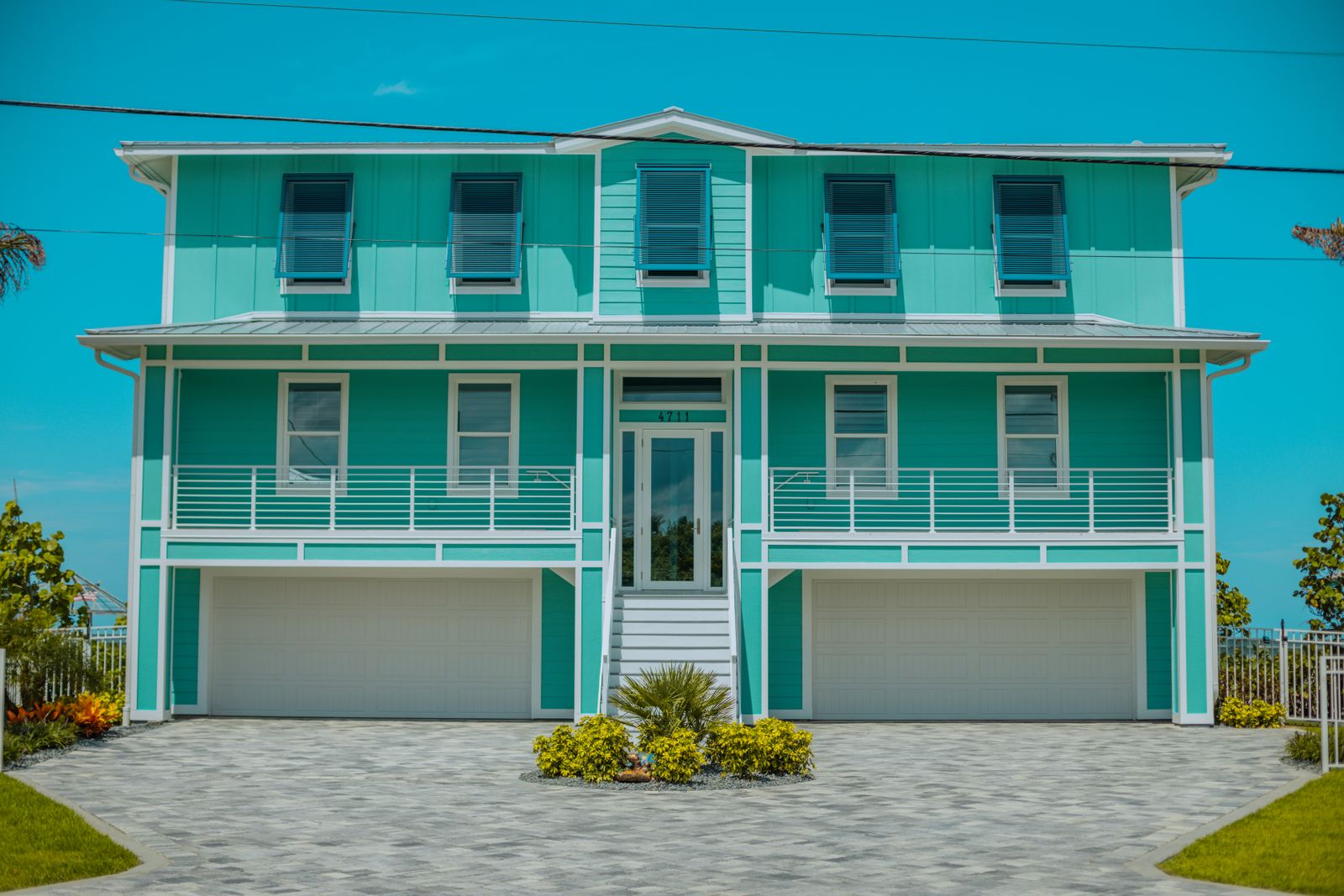 Coastal Florida beach house painted teal, representative of the type of single-family collateral that backs Grade A to C performing notes