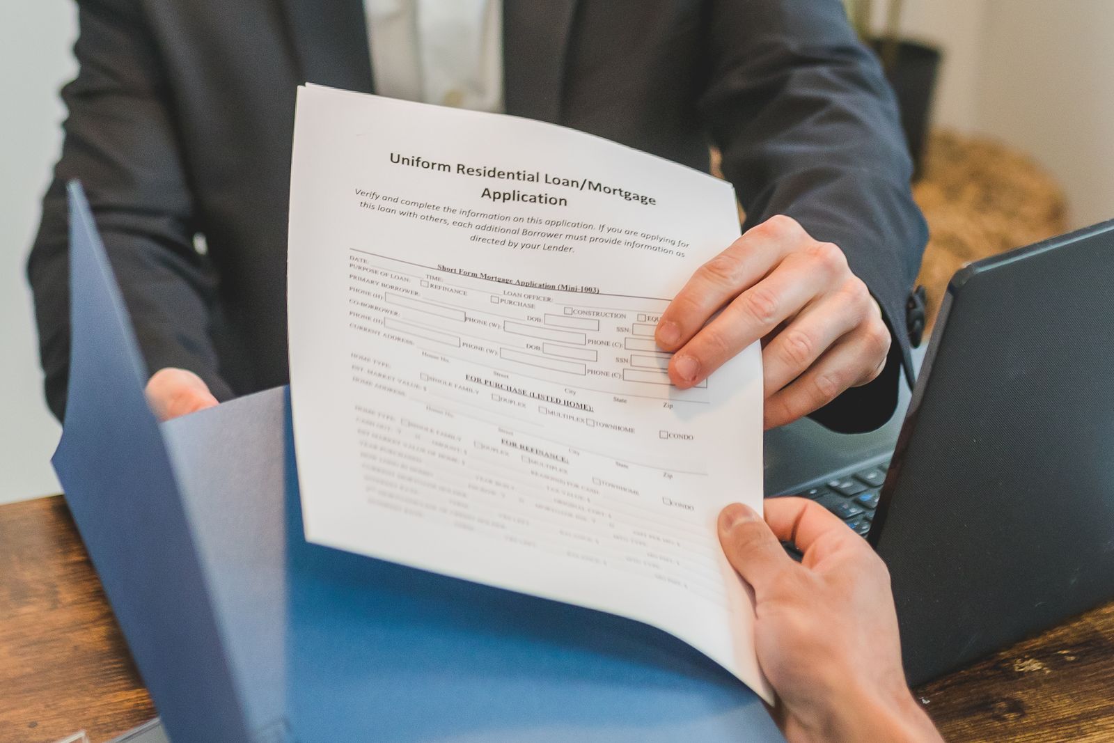 Fund representative reviewing a residential mortgage application form
