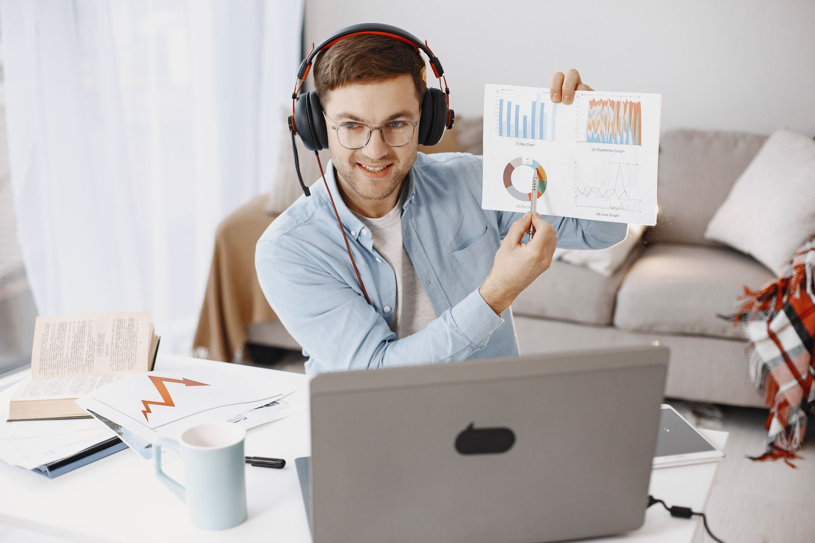 Financial educator holding up printed portfolio charts during a live investment webinar session